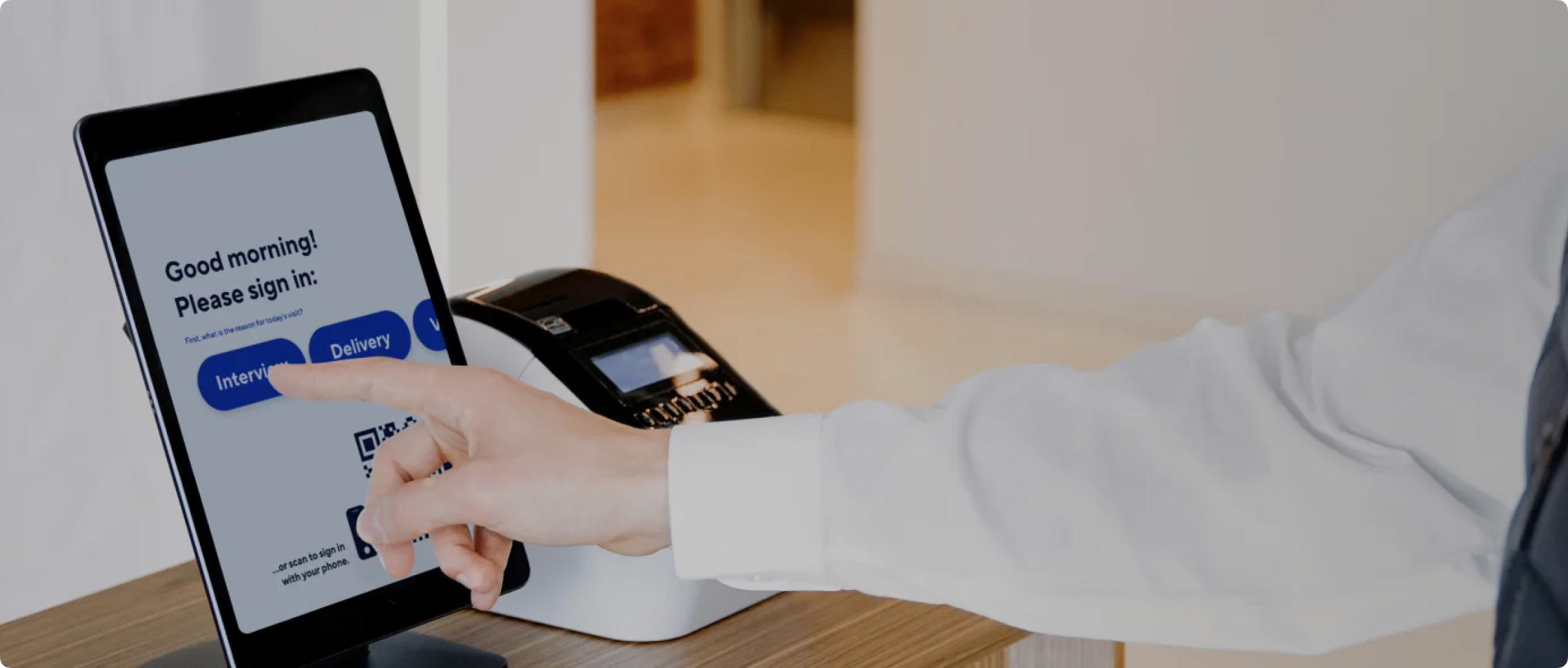 Visitor checking in at modern security desk